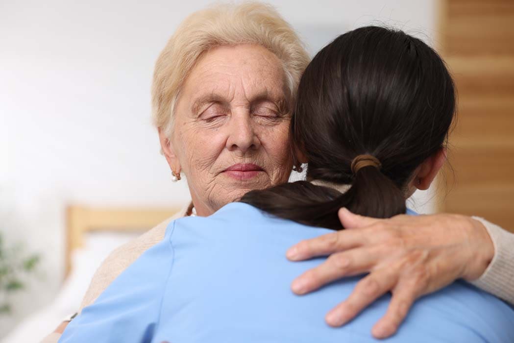 mature-woman-embraces-caregiver-with-affection-ind-2026-03-26-23-27-20-utc (1)