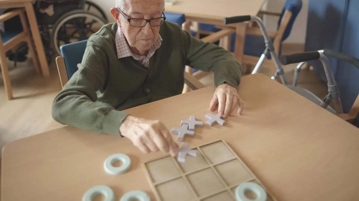 senior-man-plays-tic-tac-toe-at-table-2026-01-08-07-57-36-utc